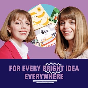 two women smiling into camera with an image of their stationary products
